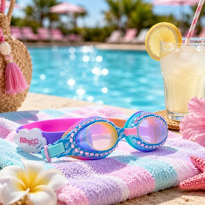 Cloud Blue Sunny Day Swim Goggles displayed beside a resort-style swimming pool with lemonade and summer accessories.