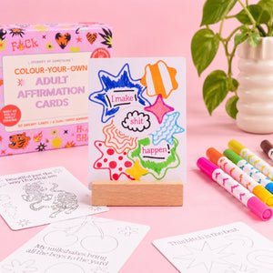 Finished adult affirmation card displayed in the included wooden stand with markers and product box
