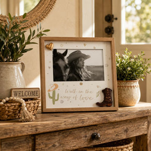 Framed photo Walk in the name of Love of a couple with a horse, decorative items on a wooden surface.