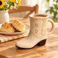 Cowboy boot ceramic mug filled with coffee on a wooden table