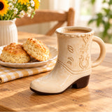Cowboy boot ceramic mug filled with coffee on a wooden table