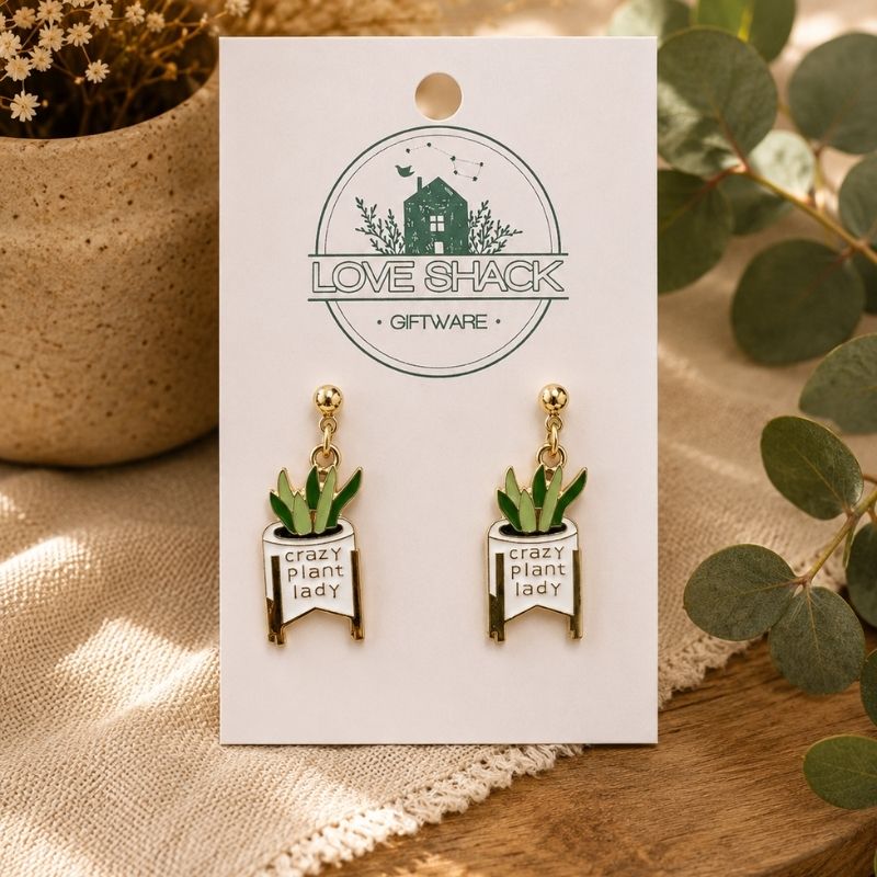 Crazy Plant Lady dangle earrings on a card with 'Love Shack Giftware' branding, surrounded by greenery.