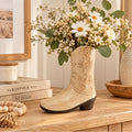 Cowboy boot ceramic vase styled with flowers on a console table