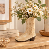 Cowboy boot ceramic vase styled with flowers on a console table