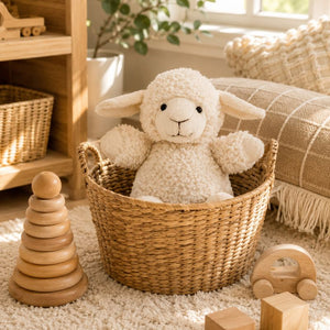 White curly sheep plush toy sitting in woven basket with wooden toys in farmhouse nursery by Love Shack Giftware
