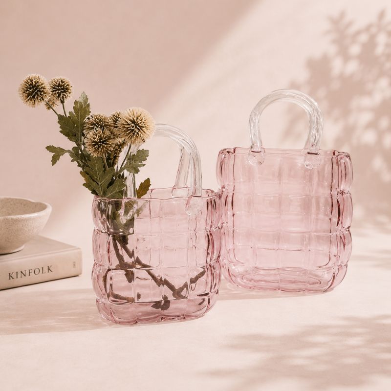 Pink glass bags with floral arrangement on a soft pink background