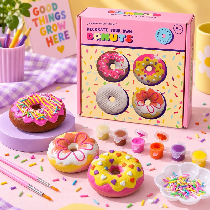 Colourfully decorated plaster donuts displayed with the Journey of Something craft kit