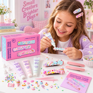 A young girl with long light brown hair smiles while applying colorful hair clip decorations to a pink hair clip. She is wearing a lavender daisy sweater and matching hair clips.
