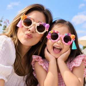 Adult and child wearing colourful decorated flower-shaped sunglasses
