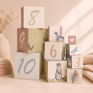 Deer Stacking cubes of decorative blocks with numbers and animal illustrations on a soft pink background