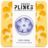 Drinks Plinks - Retro Daisy Yellow Ice Cube Tray in a yellow square tray with a white center label showing a flower-shaped clear ice cube and the text 'retro daisy for flower power attitude'.