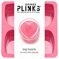 Drinks Plinks -Big Heart Pink Ice Cube Tray shown with a white vertical label in the center featuring the brand name 'DRINKS PLINKS' and a heart-shaped pink ice cube in a glass, with the text 'big hearts for love with attitude'.