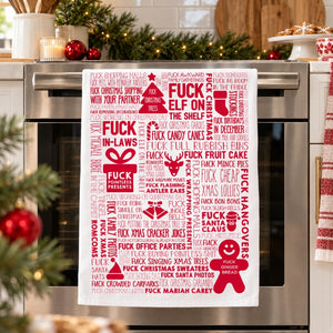 F Word Xmas Red tea towel hanging on an oven handle in a festive kitchen