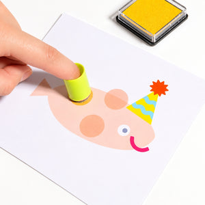 Close-up of child using a finger stamp tool to make fingerprint artwork
