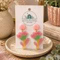 Handmade Floral Dangle Earrings featuring colorful flower-inspired polymer clay designs in pink, green, and yellow tones by Love Shack Giftware.