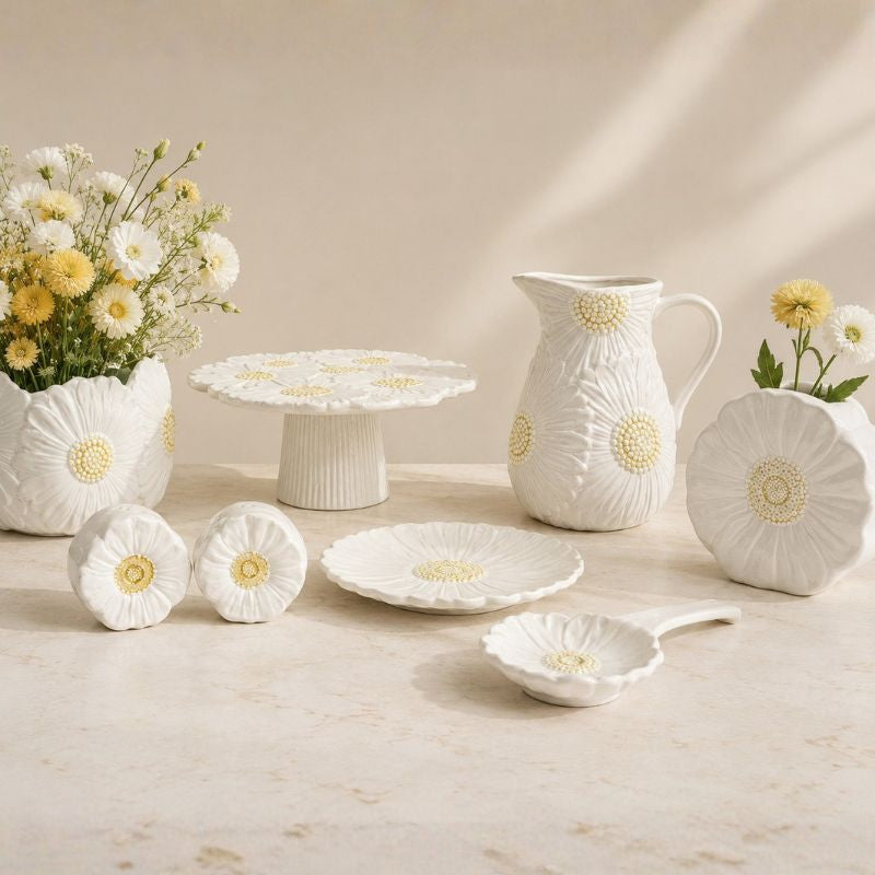 White ceramic tableware set with floral designs on a beige background