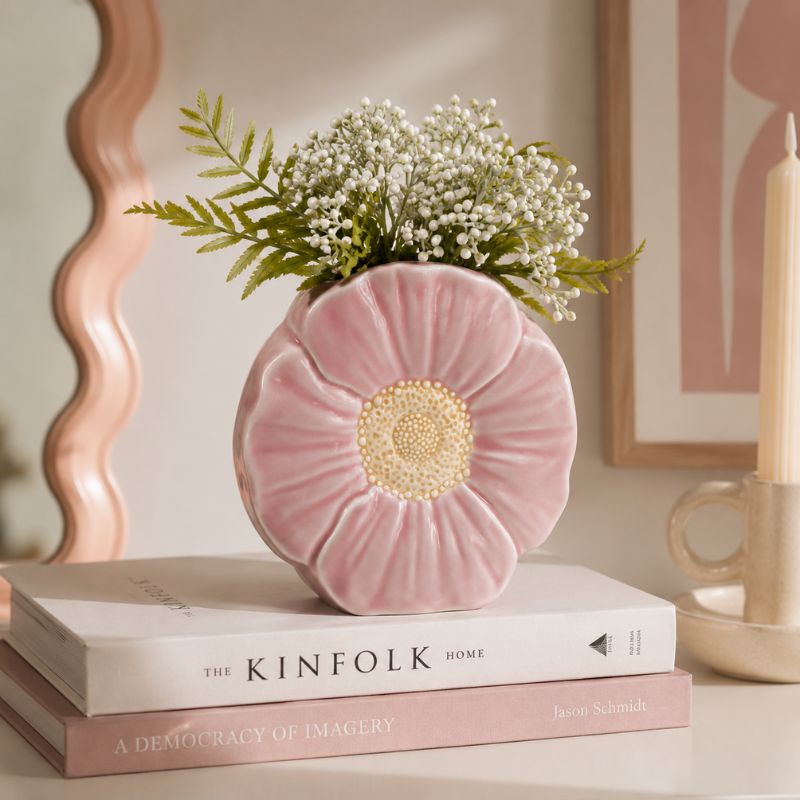 Pink flower-shaped vase with greenery on top of books in a home - decor setting—Loveshack Giftware
