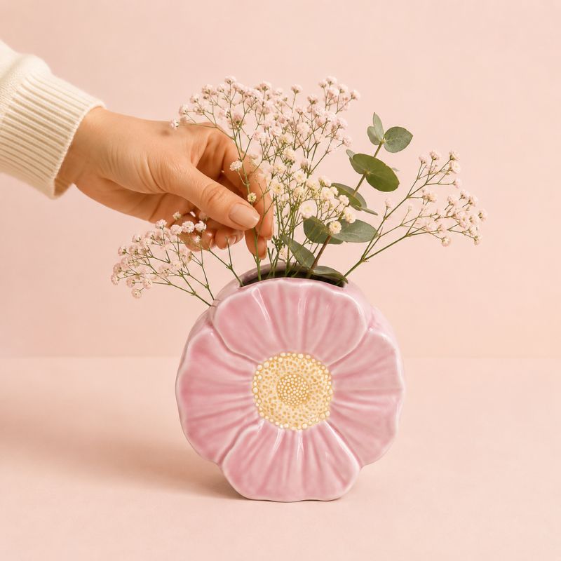 Pink flower-shaped vase with a hand placing flowers on a pink background-Loveshack Giftware