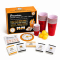 Precarious Cheeky Chest of Tipsy Trials drinking game set with orange and black retail box, red plastic cups, yellow balls, cards, spinner, and other game pieces on a white background.
