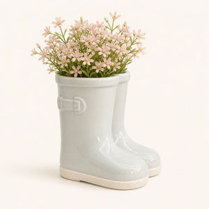Sage gumboot plant pot styled with flowers on wooden surface