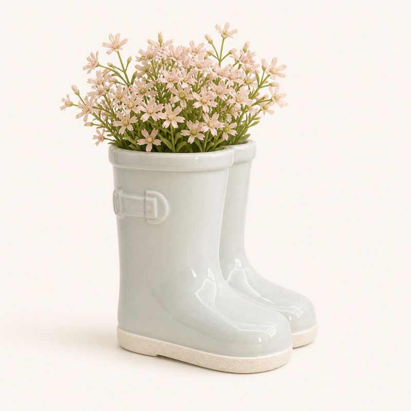 Sage gumboot plant pot styled with flowers on wooden surface