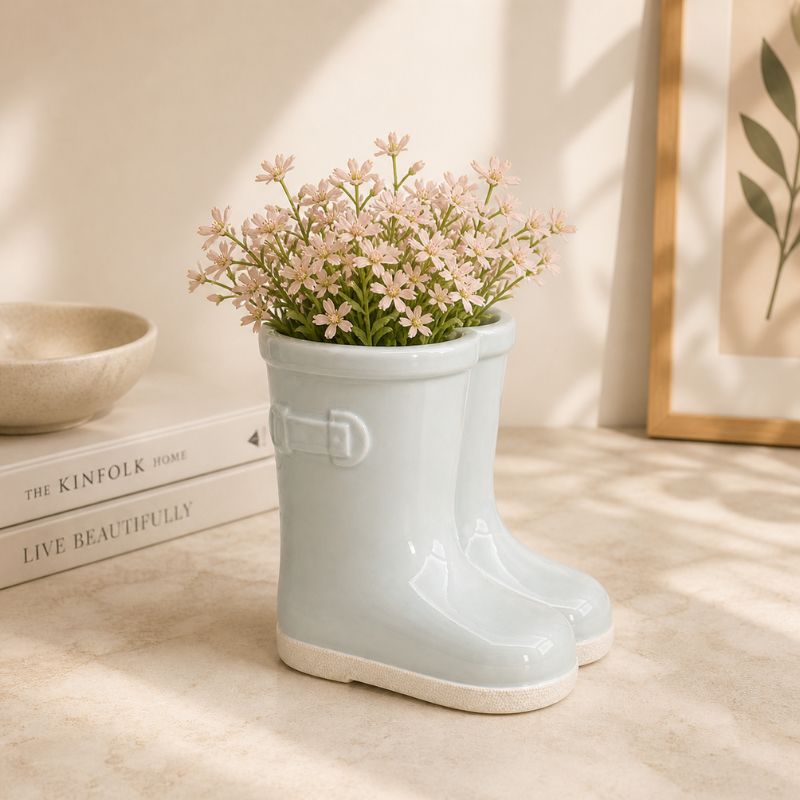 Sage green boot planter with flowers in minimalist home decor