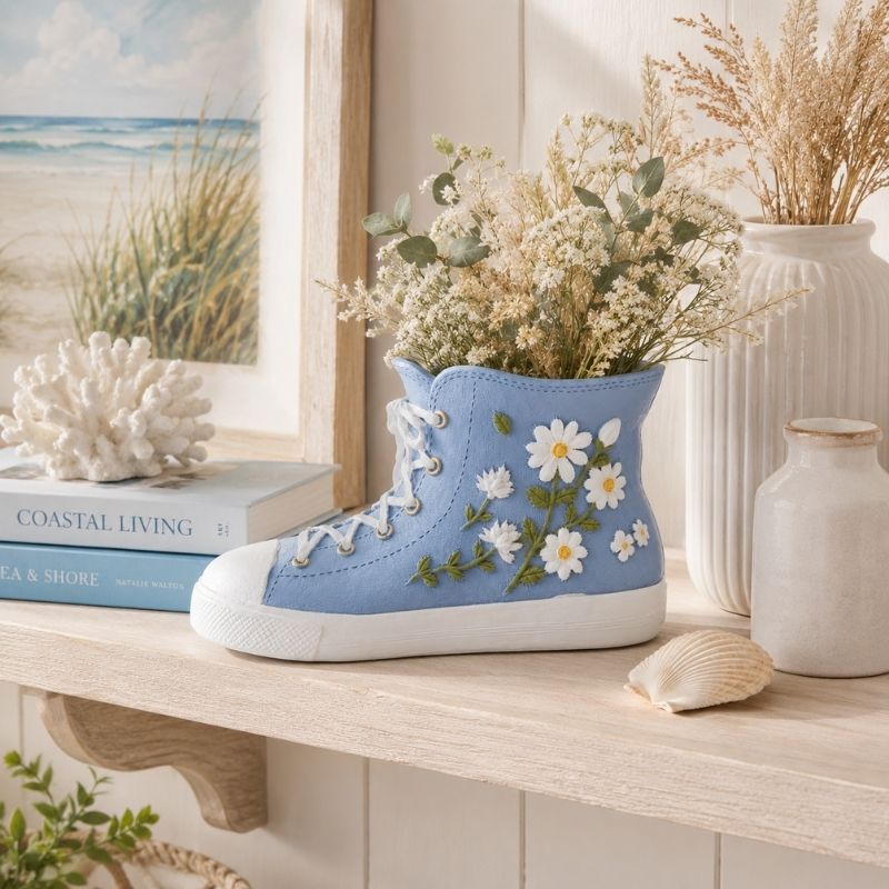 Gym Boot Resin Vessel Blue 11cm on a shelf with decorative items