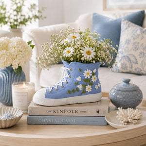 Gym Boot Resin Vessel Blue 11cm on a coffee table with books and decor items.