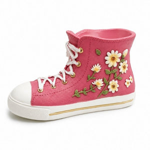 Pink floral gym boot resin planter vase with white daisy embellishments and lace-up sneaker design on a white background.