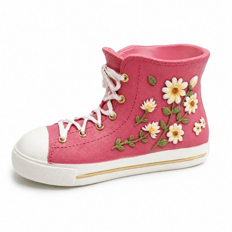 Pink floral gym boot resin planter vase with white daisy embellishments and lace-up sneaker design on a white background.