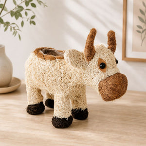 Cow planter with greenery in cozy modern home setting