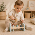 Child playing with a hammer bench wooden toy in a cozy room—Loveshack Giftware