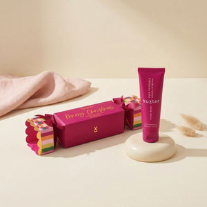 Huxter Hand Balm Bon Bon and 50ml Pink Pepper and Vanilla Bean hand balm on cream pedestal