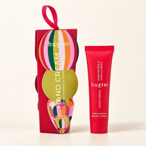 Woman applying Huxter Pink Pepper and Vanilla Bean hand cream