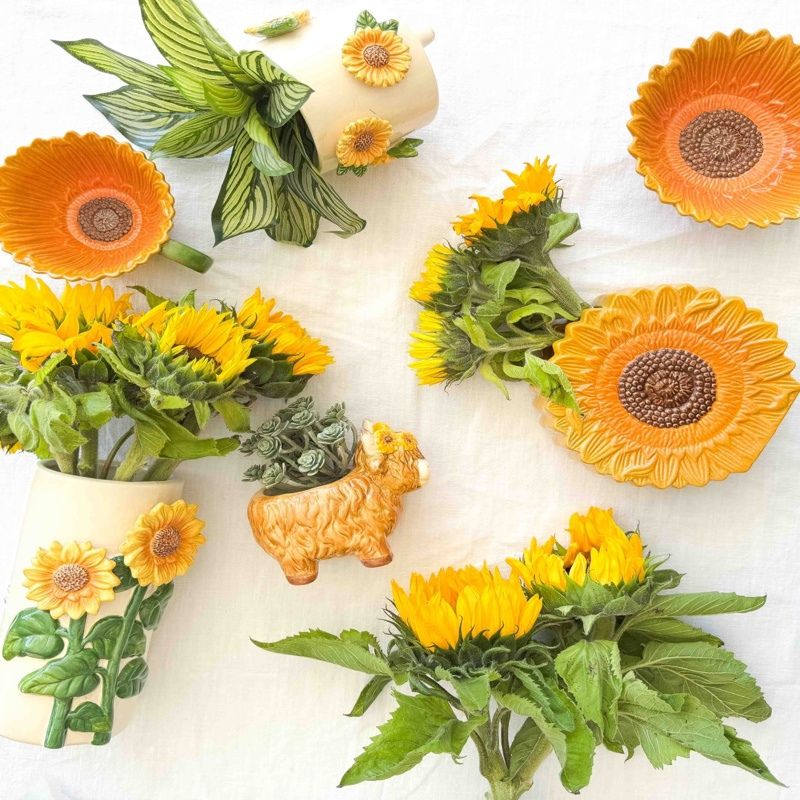 Decorative sunflower and green leaf items on a white background