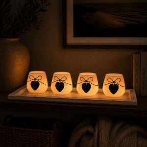 Glowing HOME candle holder tray set displayed on a shelf in a cozy evening setting with warm ambient lighting.