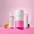 Hustle shower pamper duo with body wash, shower gel, and scrub on a pink background