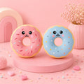 Sprinkle Squeeze Donut with faces on a pink background