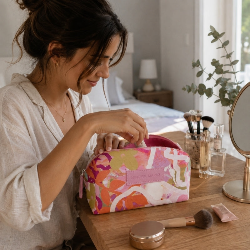 Mindful Marlo Ivy makeup bag with beauty essentials on a wooden vanity