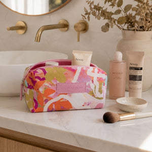 Mindful Marlo Ivy cosmetic bag being used by a woman at a vanity