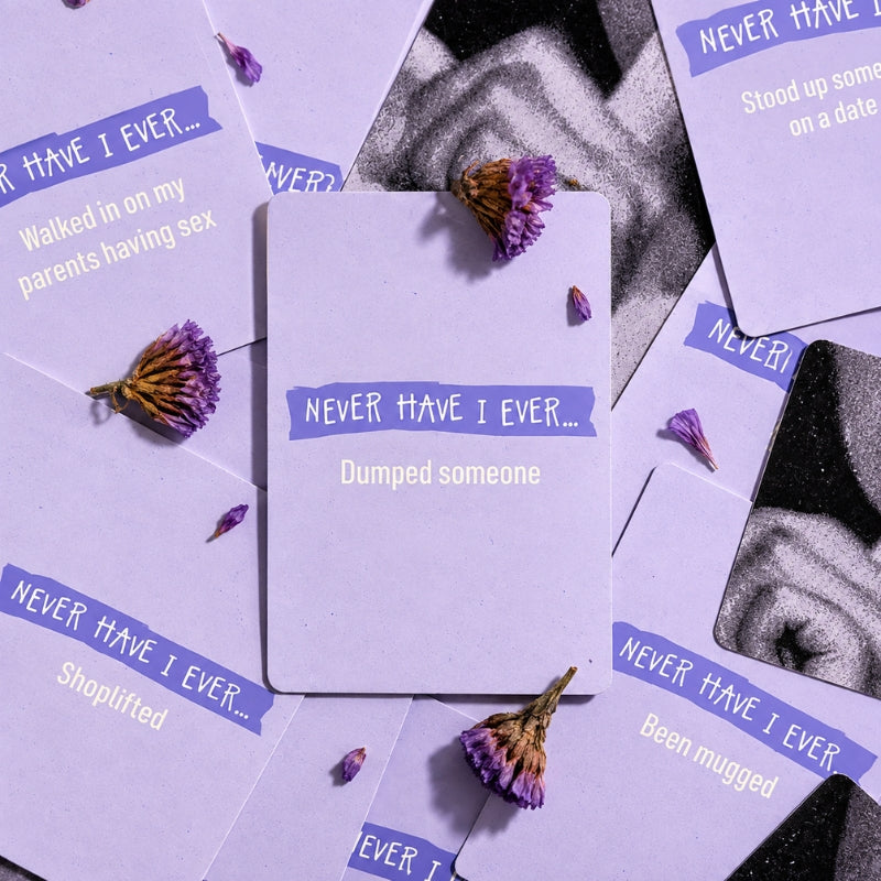 Never Have I Ever lavender cards styled in an aesthetic flat lay with dried flowers