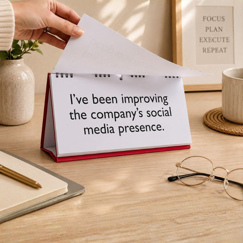 Hand opening a small calendar on a desk with text about improving social media presence.