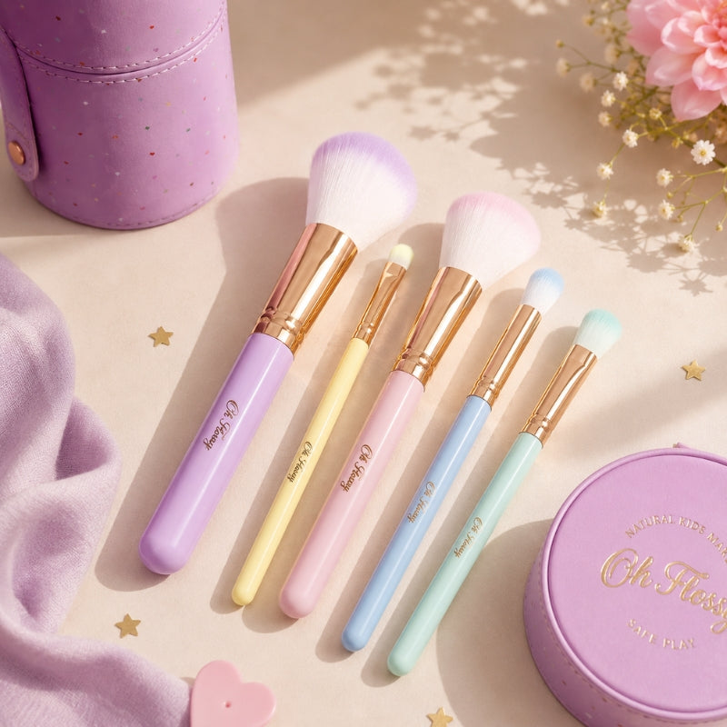 Oh Flossy 5-piece kids makeup brush set arranged on a pastel background