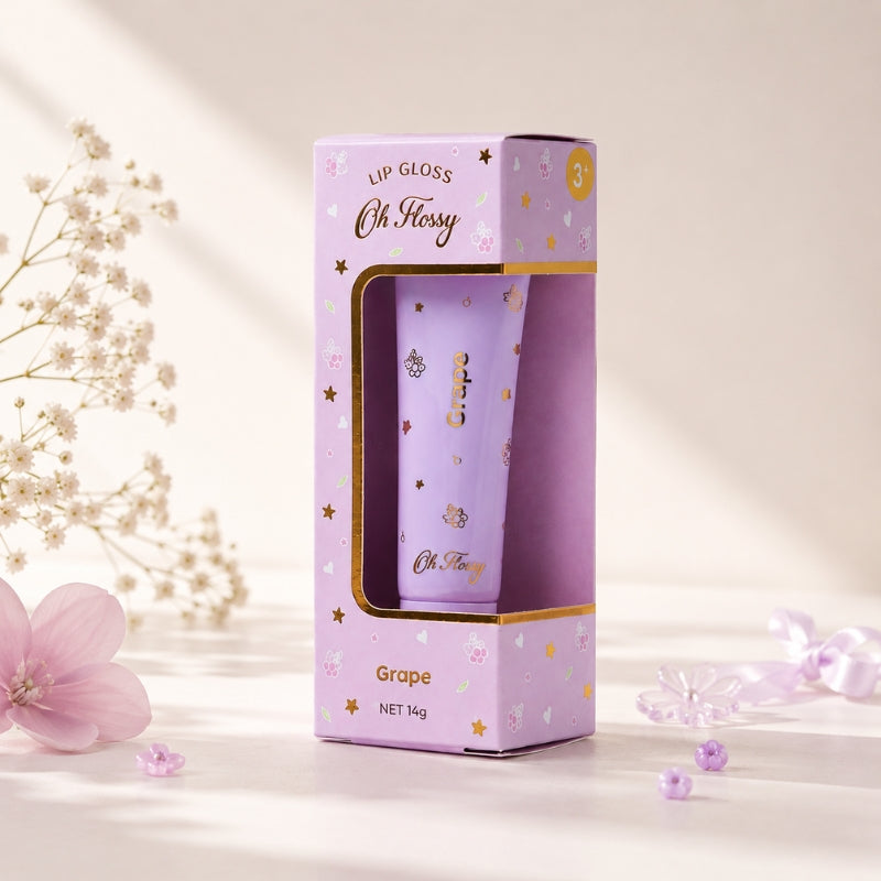 Oh Flossy Grape Natural Lip Gloss for Kids with lavender packaging in a soft floral setting