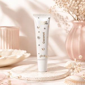 Oh Flossy Coconut Natural Lip Gloss tube in aesthetic lifestyle setting