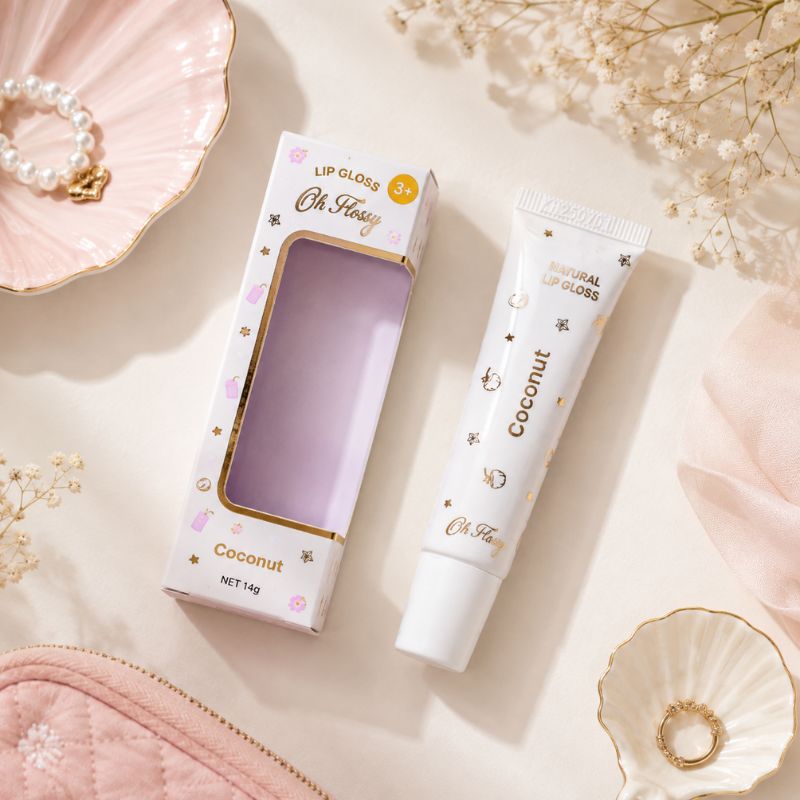 Oh Flossy Coconut Lip Gloss and packaging with pastel accessories