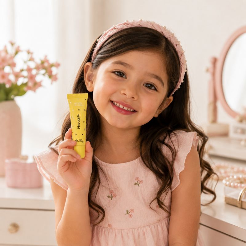 Child holding Oh Flossy Pineapple Lip Gloss during pretend beauty play