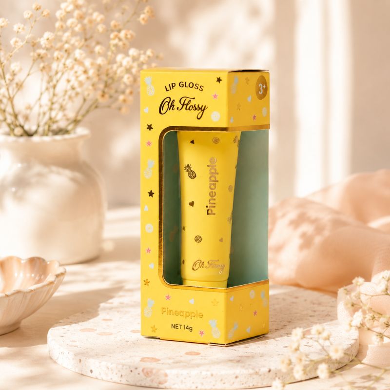 Oh Flossy Pineapple Lip Gloss for Kids displayed in yellow packaging with floral decor