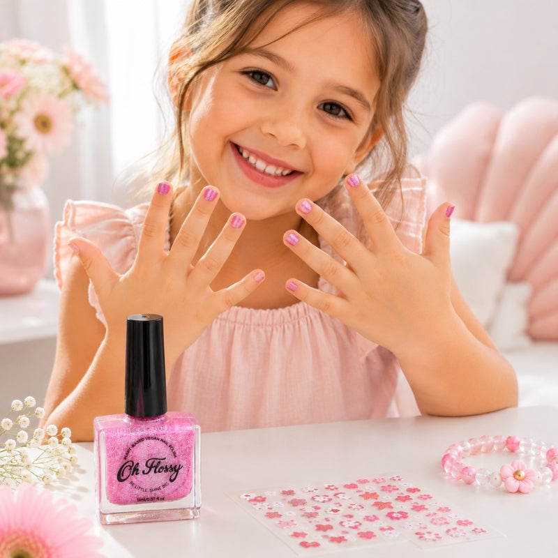 Child showing pink glitter nails with Oh Flossy Kids Nail Polish