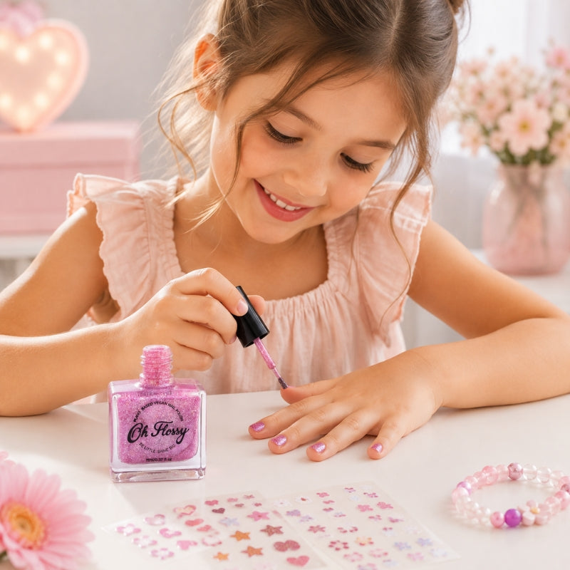 Child painting nails with Oh Flossy Pink Glitter Kids Nail Polish